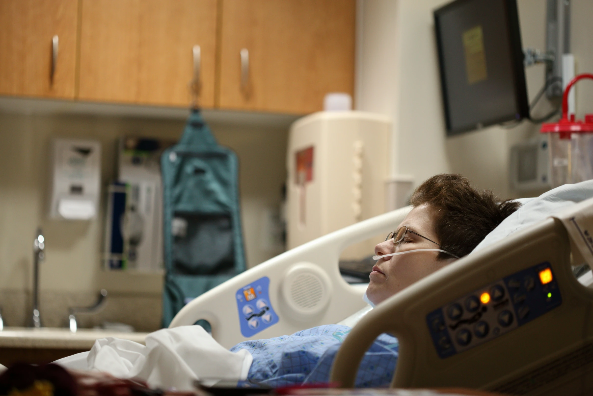 a woman is laying in a hospital bed looking up