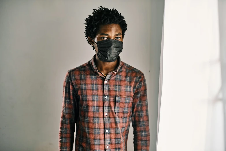 a man in plaid shirt with black face mask