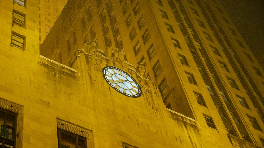 a clock hanging from the side of a building with no numbers