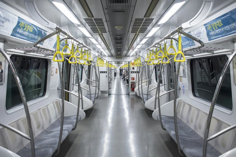 a subway with lots of rails that have yellow signs on it