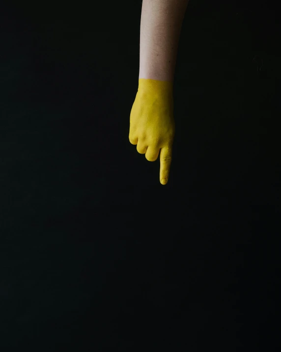 someone with yellow gloves and a pair of scissors