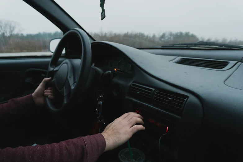 a man driving a car on a rainy day