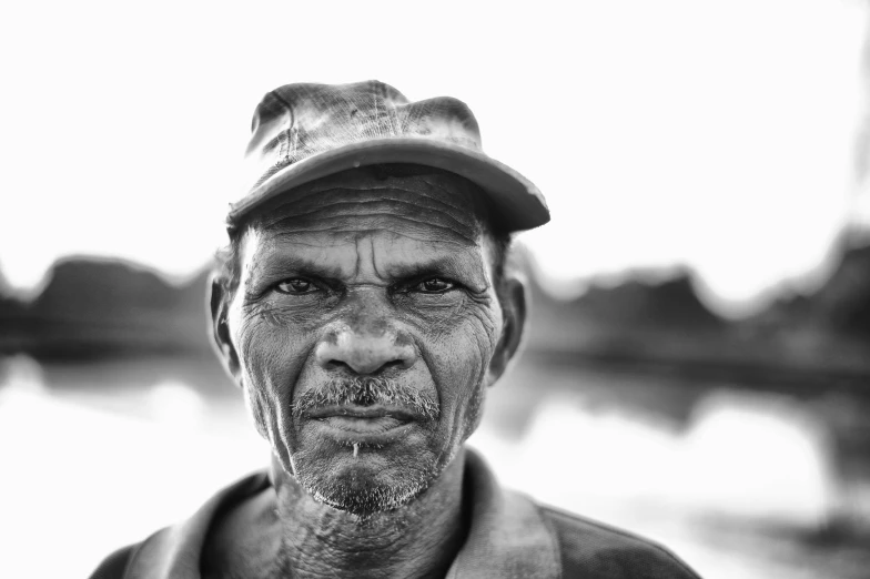 a man with hat, looking straight into the camera