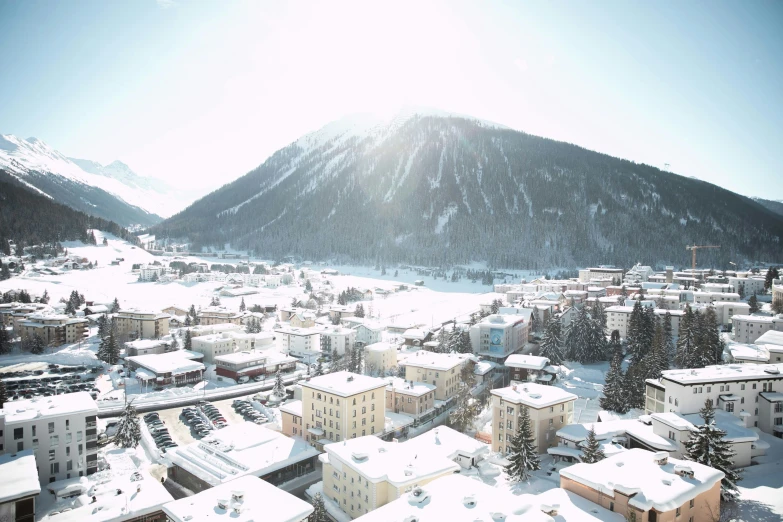 a town on a hill with many snowy mountains