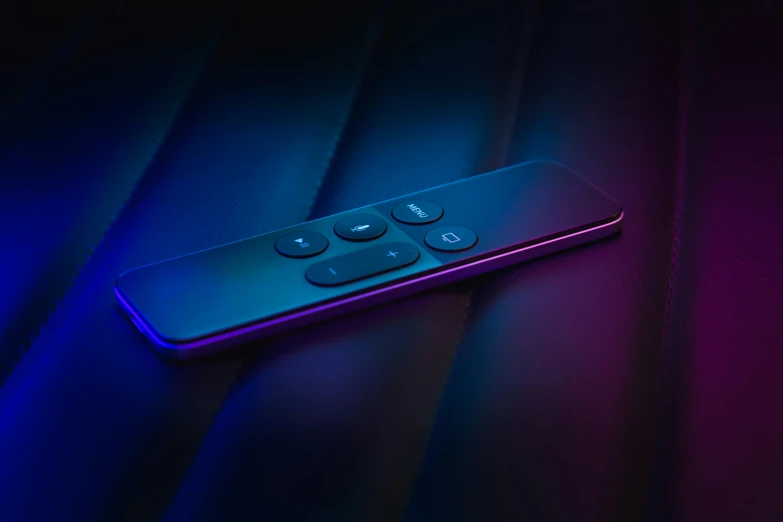 a blue and pink remote control sitting on a table