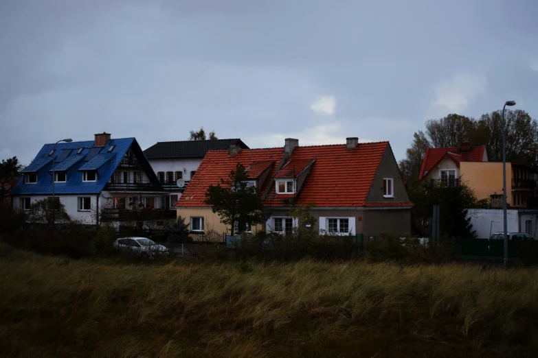 a row of houses with red roof tops