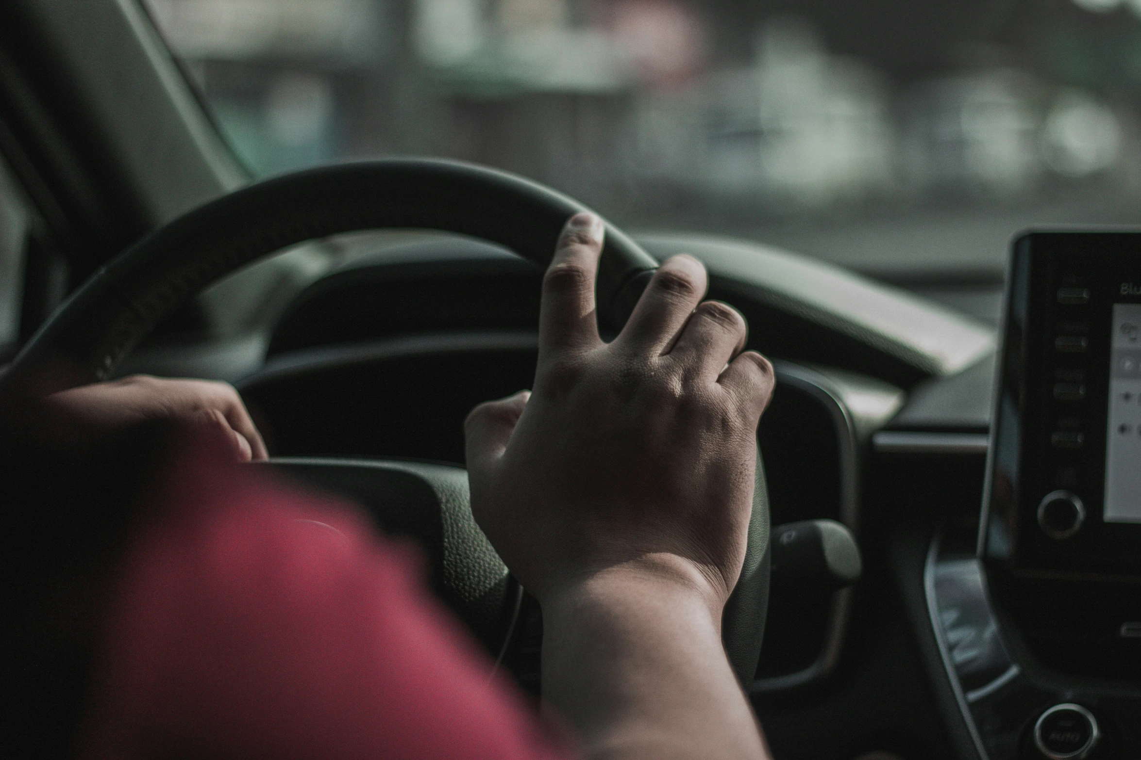 hand of a person on the steering wheel