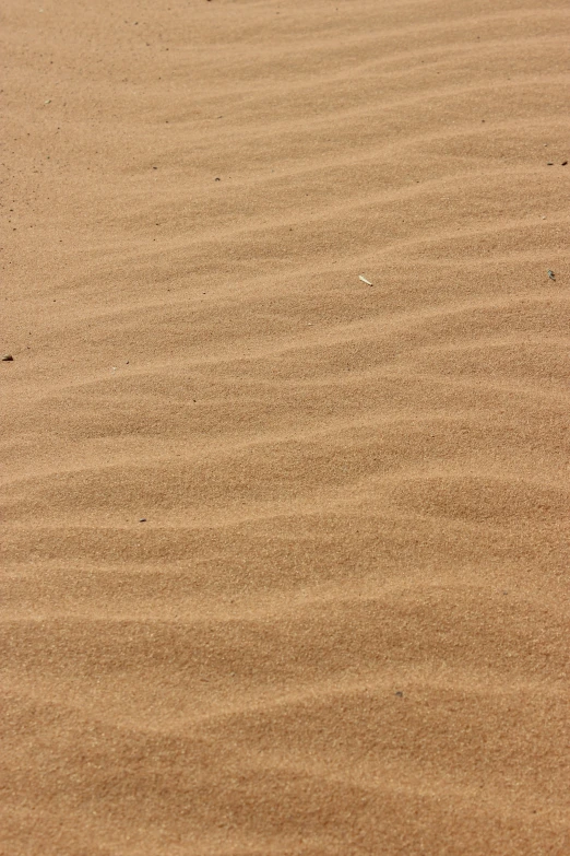 a red object sitting in the sand at the beach