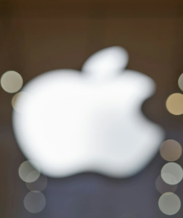 the apple logo is visible behind a round glass