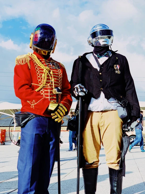 two people dressed in historical garb are posing for the camera