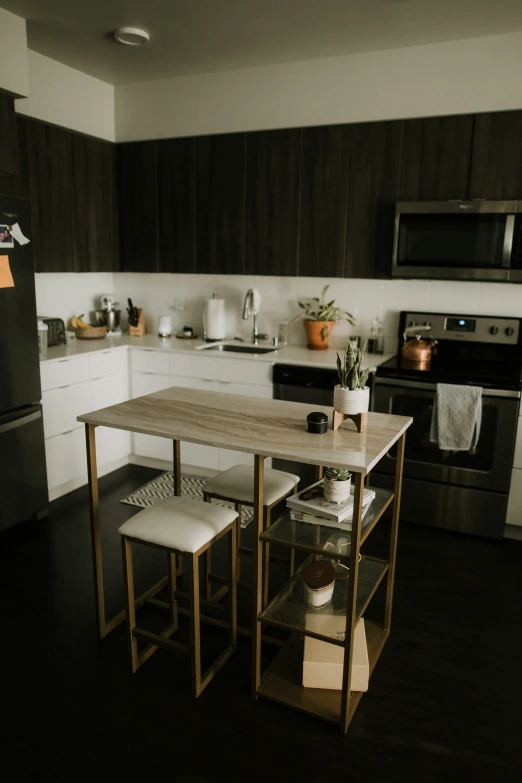 the kitchen has an island in front of the stove