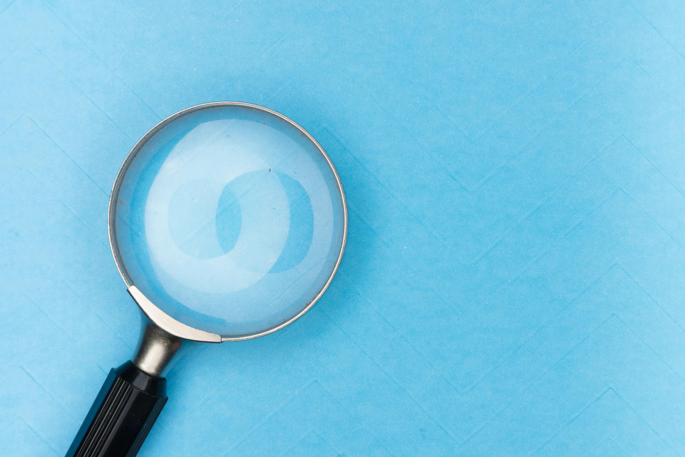 a magnifying glass sitting on top of a blue table