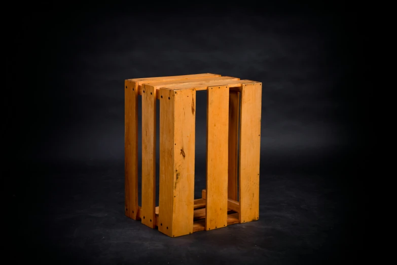 small wooden cube structure against black background