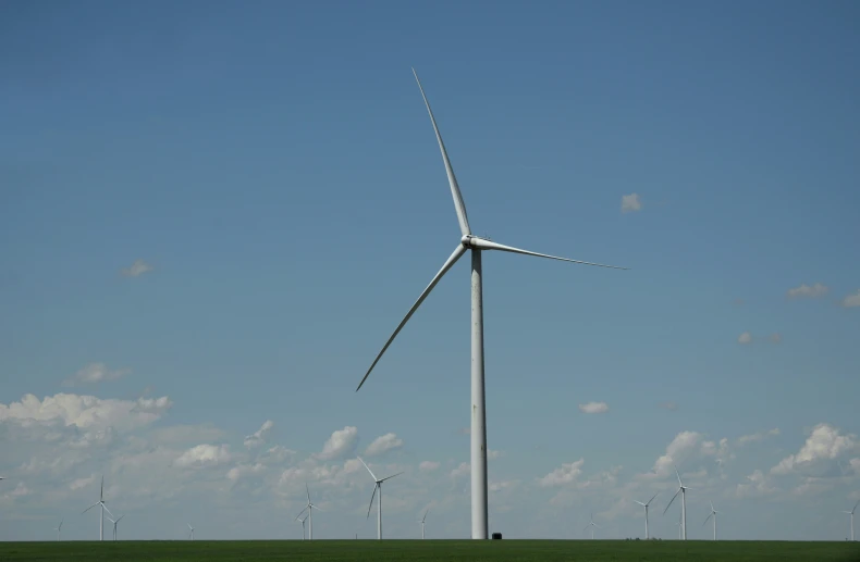 wind turbines on a green grass field during the day