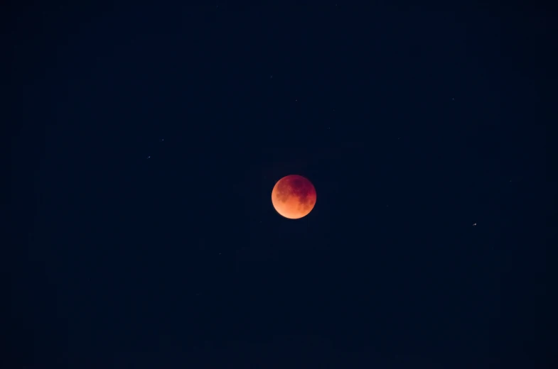 the moon partially eclipse as it passes through the sky