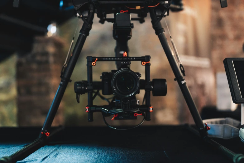 camera with red flash lights is on a tripod