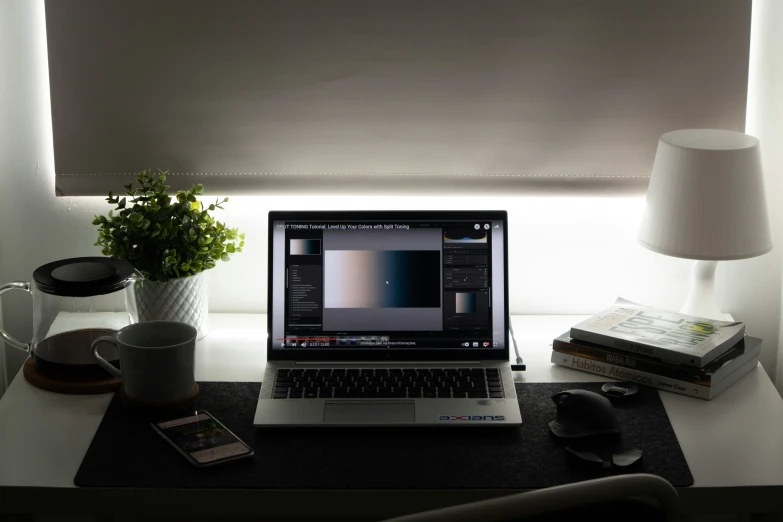 there is a laptop computer on a table with the curtains closed