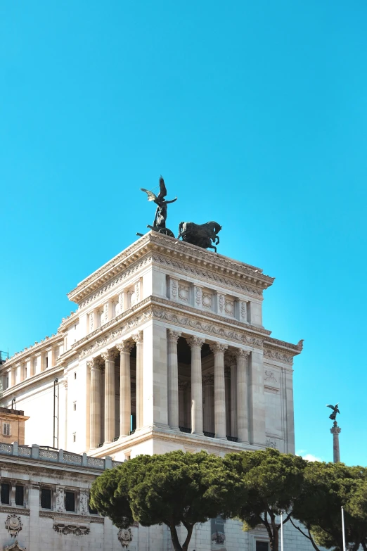 a very tall building with statues on top