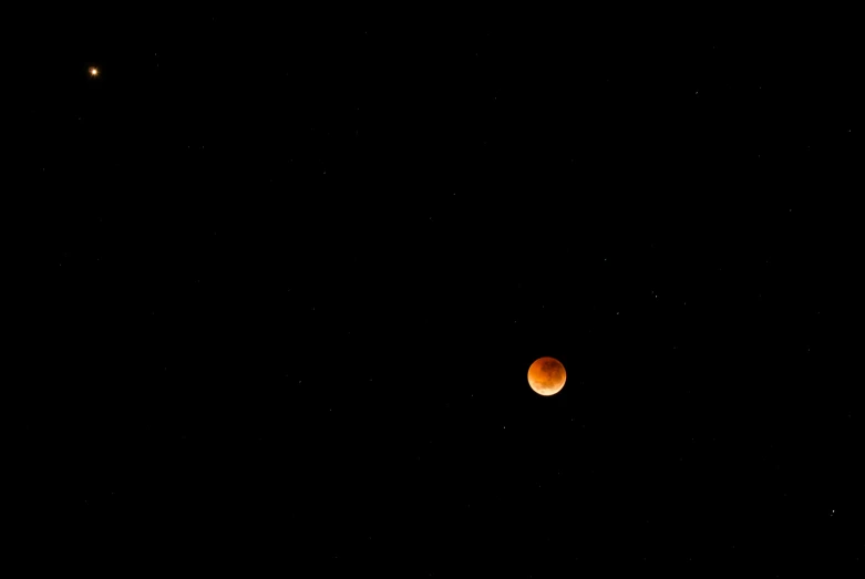 a couple of moon are visible with the night sky