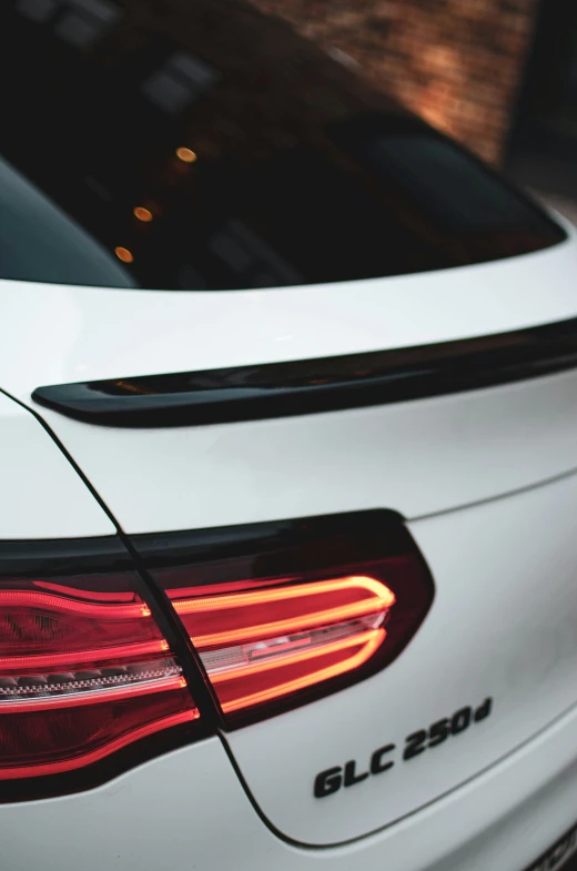 a close up po of the tail lights on a white car