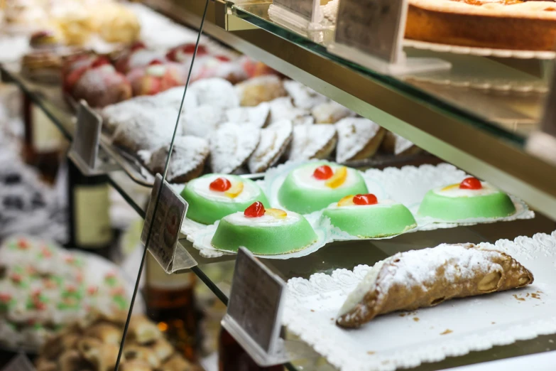 a bakery with many kinds of food being displayed in trays