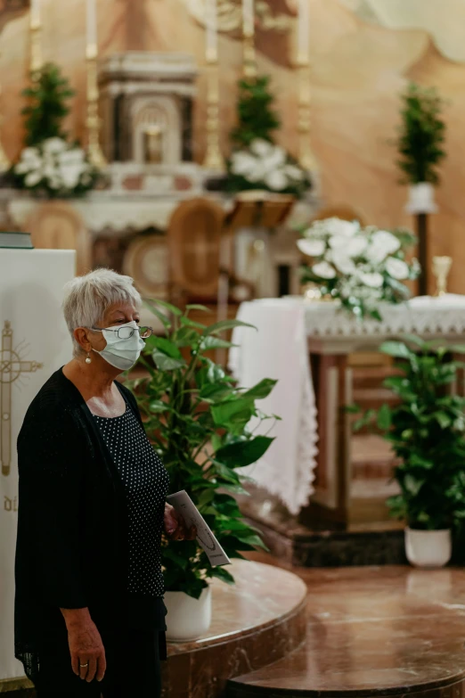 a woman in a mask holding onto soing