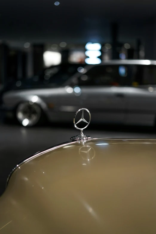 a car in the background and a mercedes benz logo