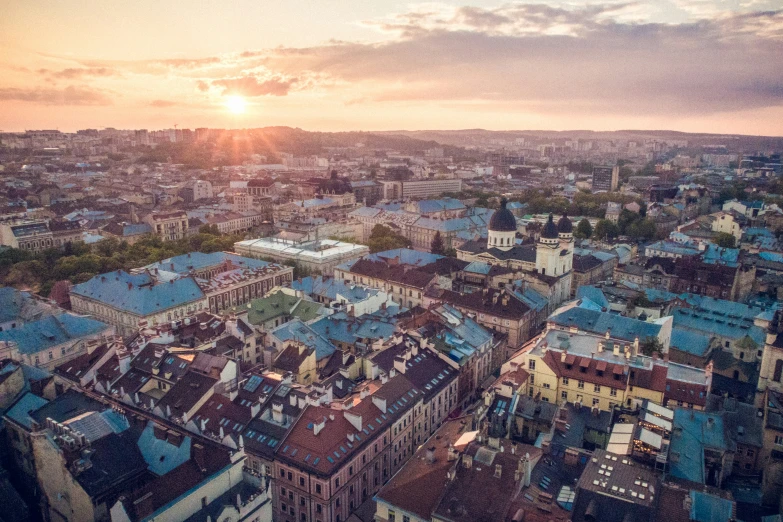 the sun setting over a very large city