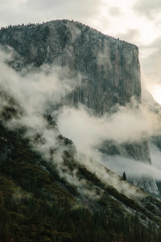 mountains shroud by a mist covered hillside