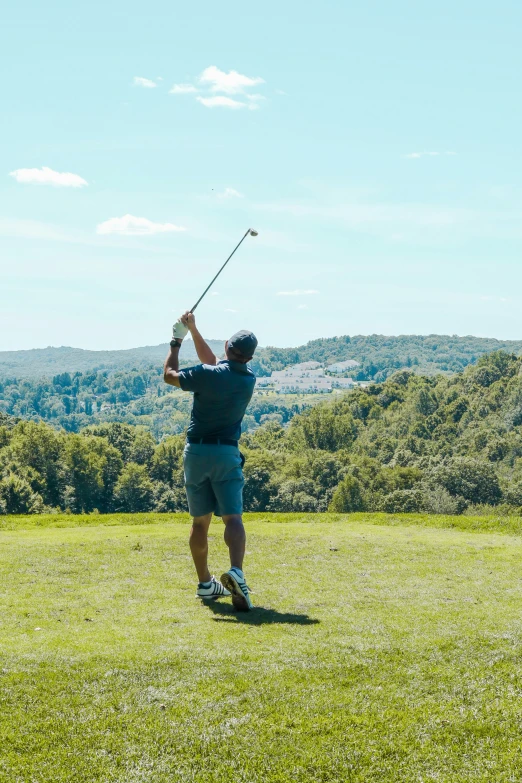 there is a man playing golf in the park