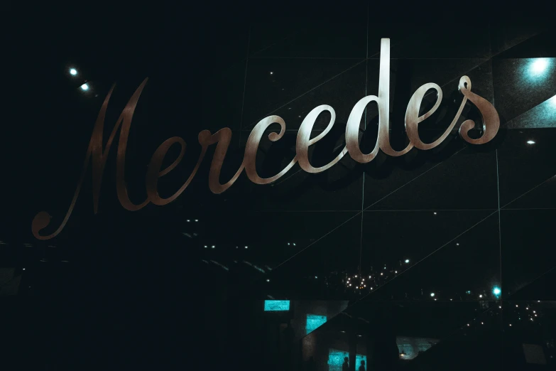 the name mercedes illuminated in red light