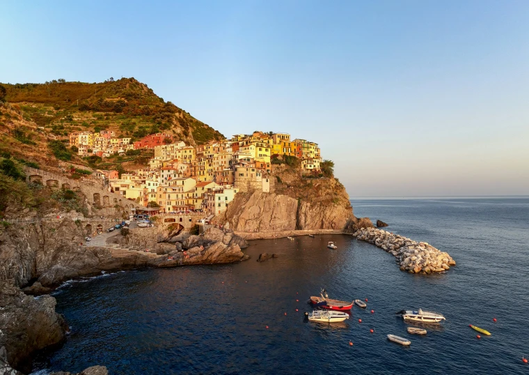 a large cliff that has boats sitting on top of it