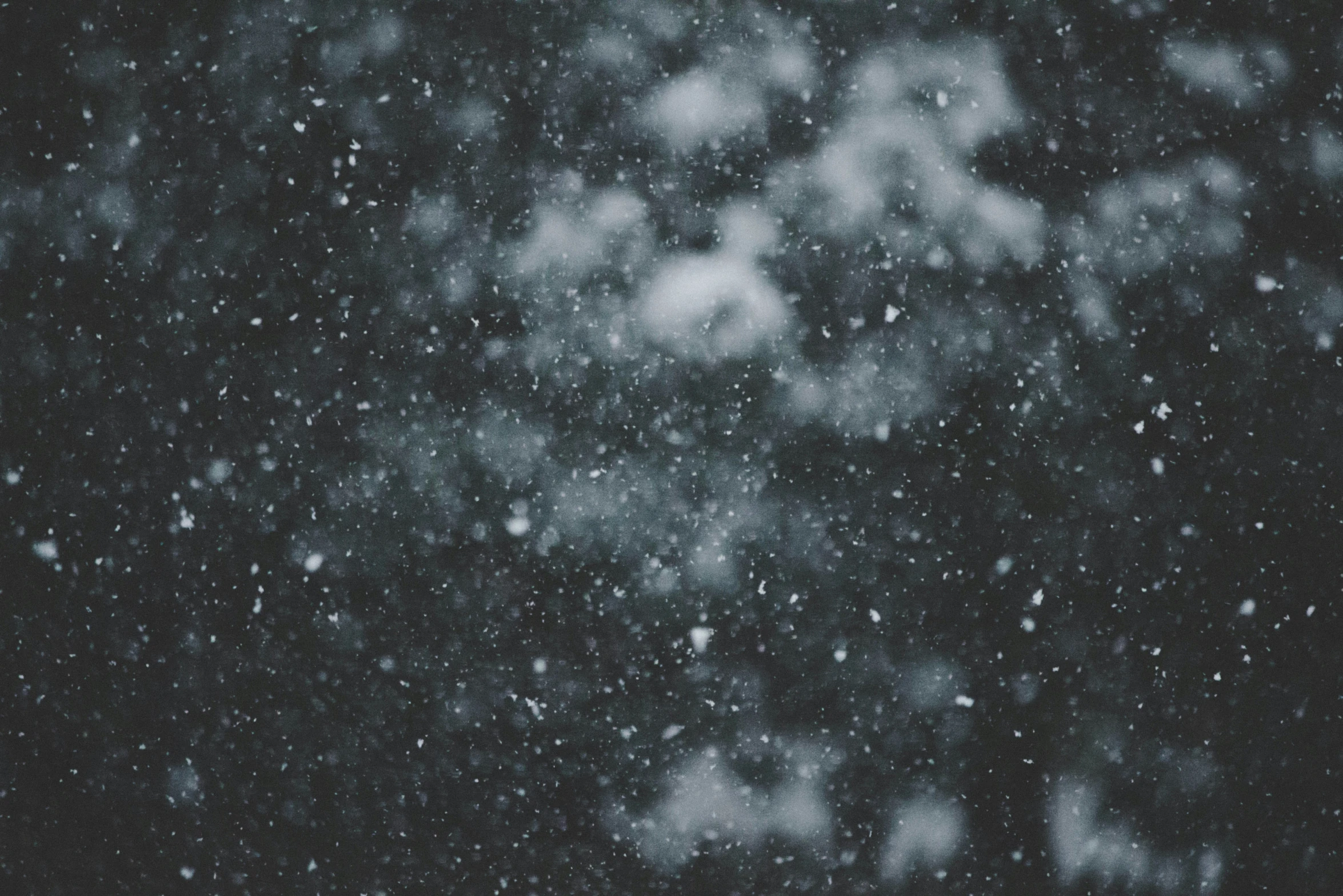 a white vase sitting on top of a table covered in snow