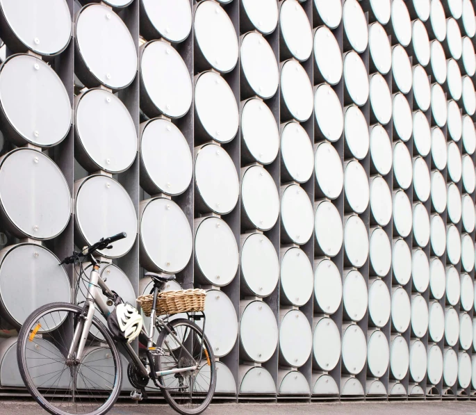 a bike next to a wall with circles on it