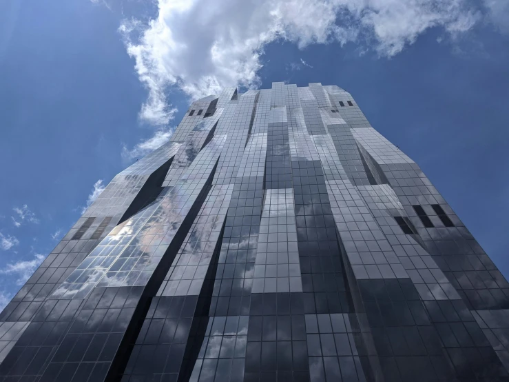 a tall building is covered with black tiles