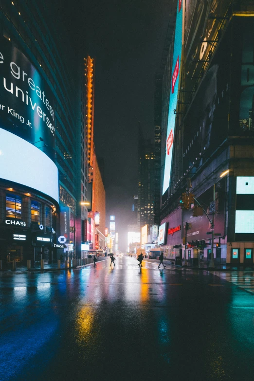 people on the street in the rain near big buildings