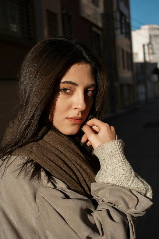 a beautiful young woman standing in the middle of a street