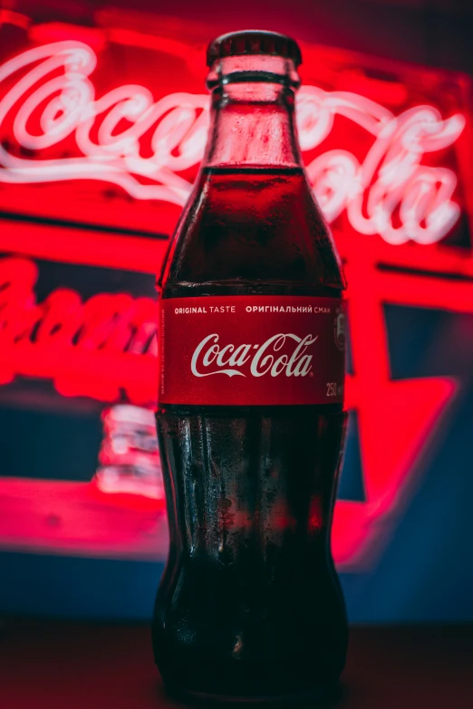 a large coca cola bottle is on the counter