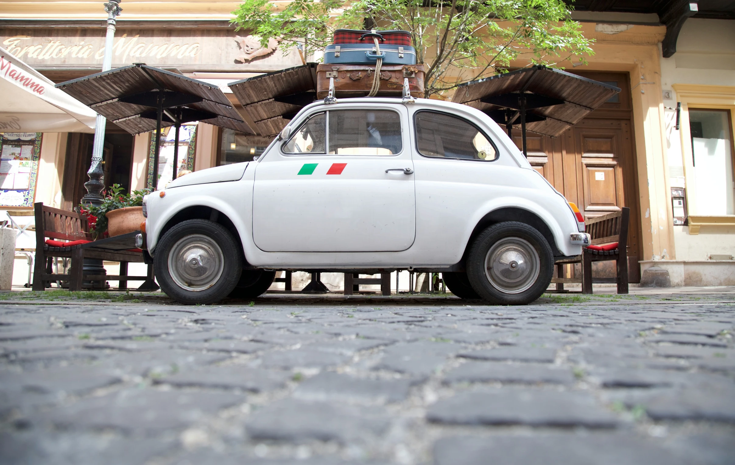 a white car sitting in front of a building