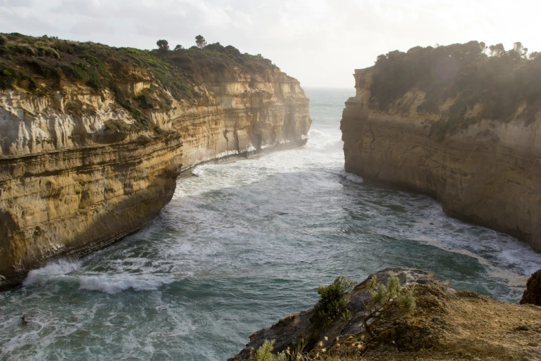 the water is wavy, a great contrast to this rock face