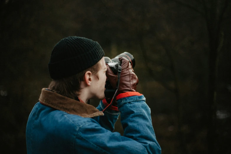 a man is standing outside and looking through a telescope