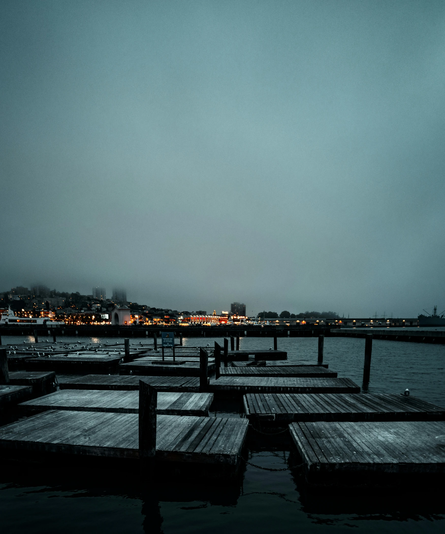 a dock with a few boards in the water