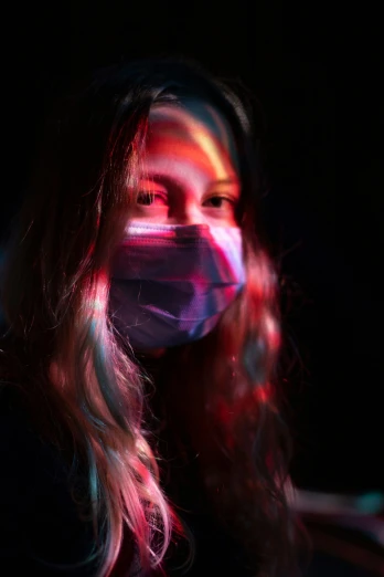 woman with face mask and hair in the dark