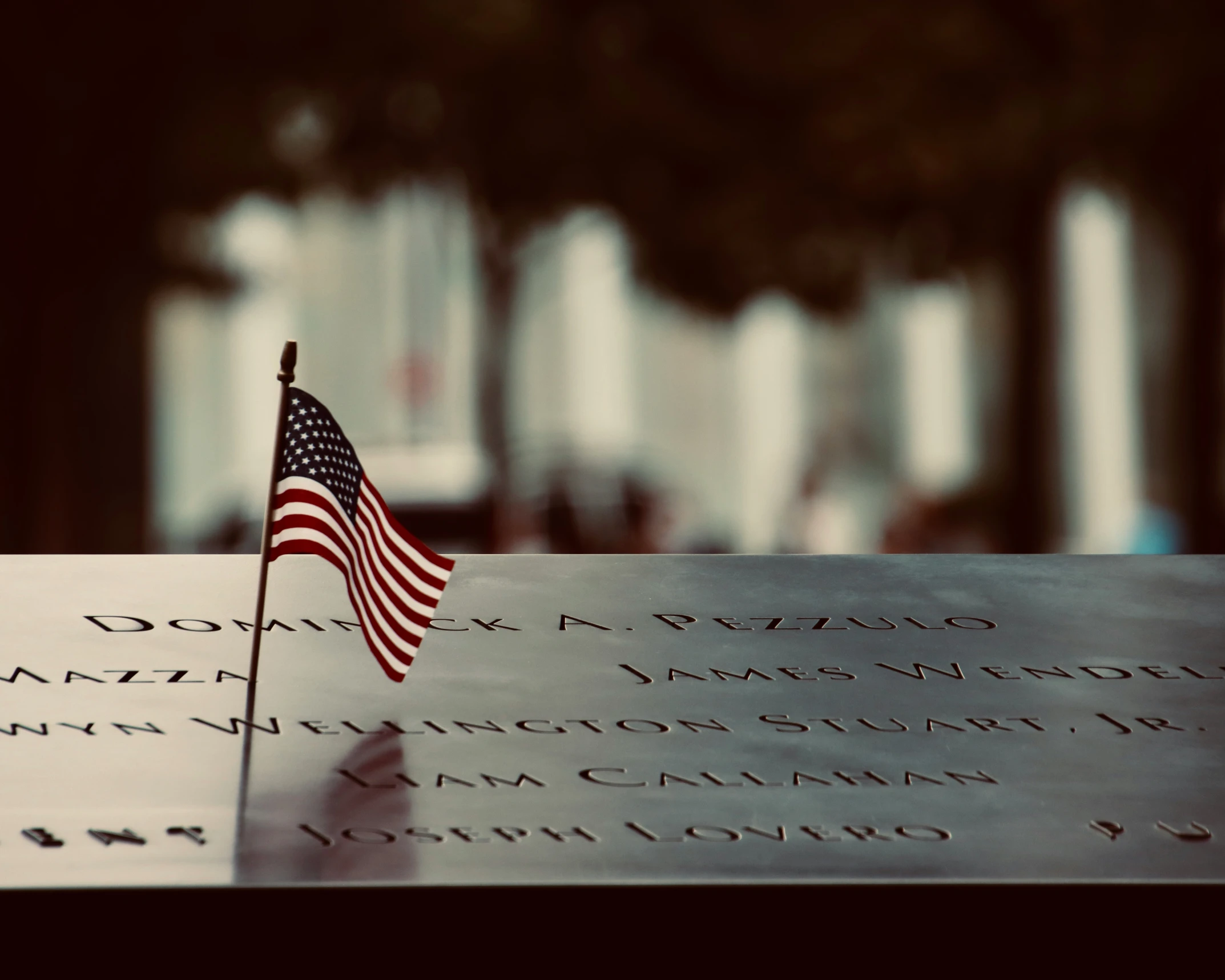 a flag laying in front of a war memorial