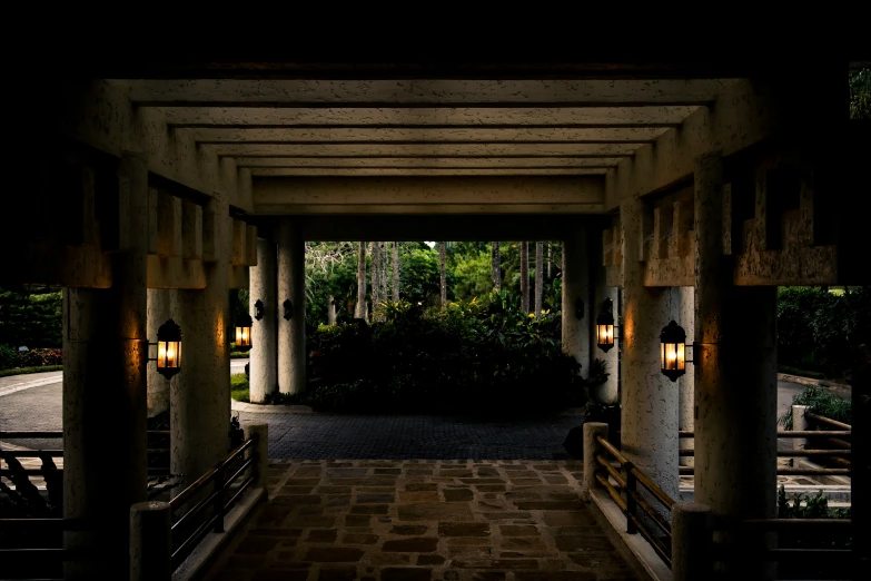 a walkway covered in lots of lights and arches