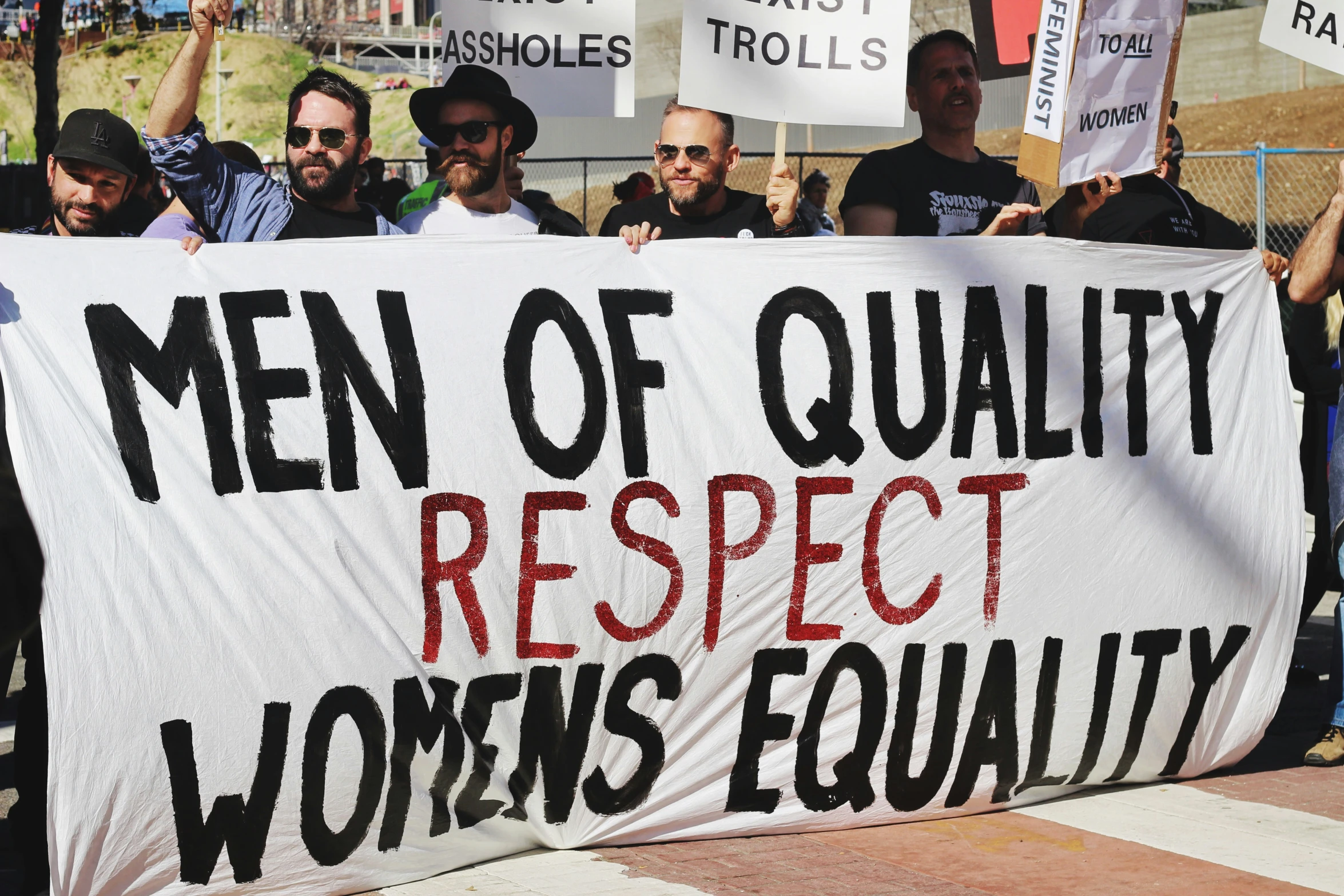 some men are holding up a large white sign