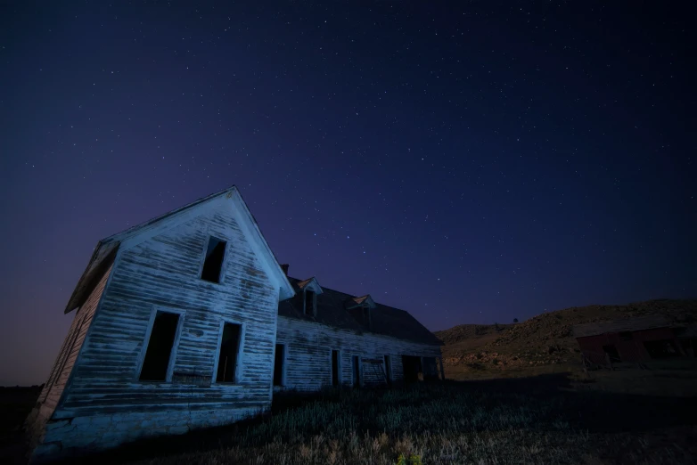 an old, run down barn and some stars