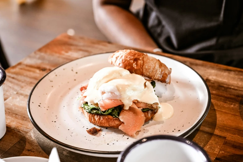 a plate filled with a breakfast sandwich and sour cream