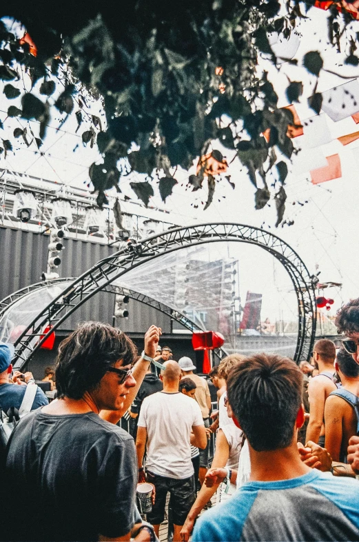 a crowd of people standing around with an overhead projector