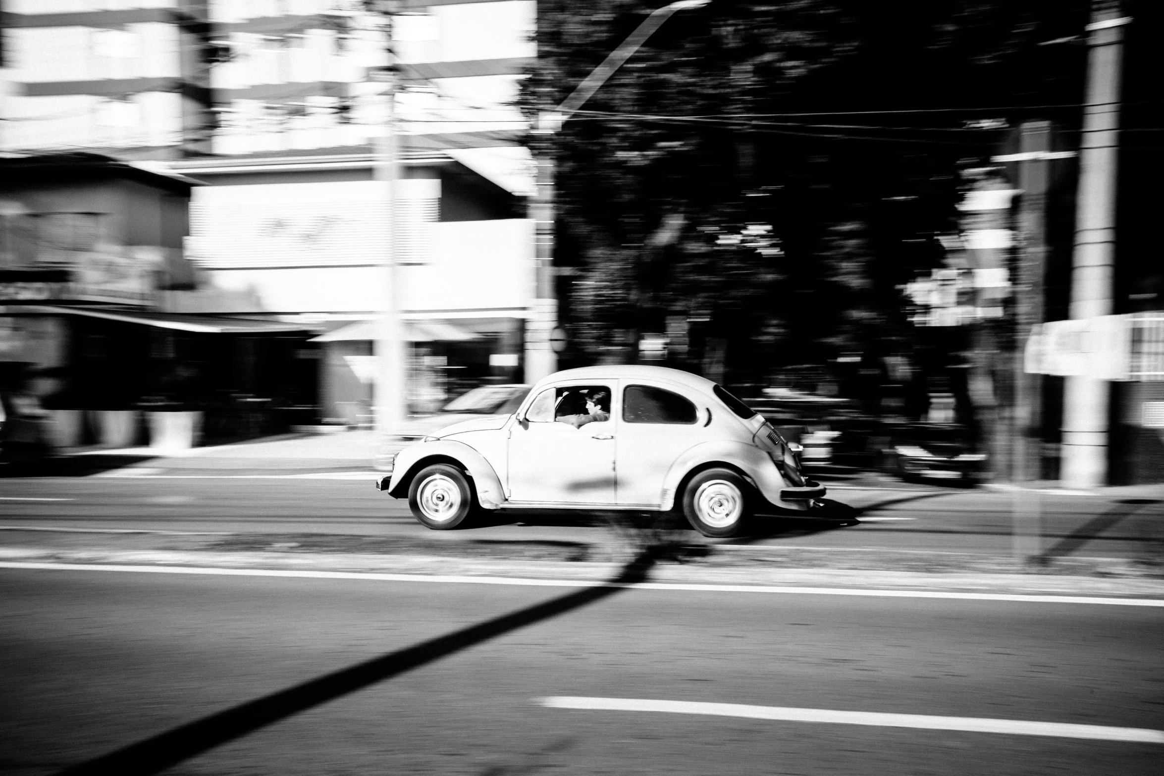 an old car sitting on a city street